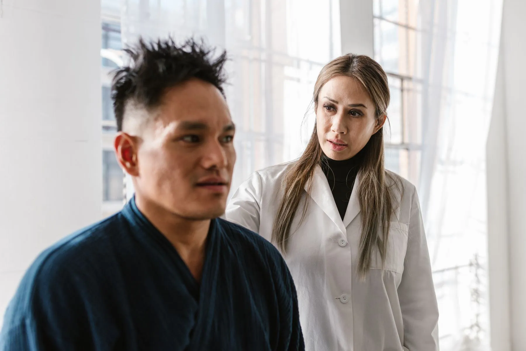 Doctor examining a patient in a bright clinic