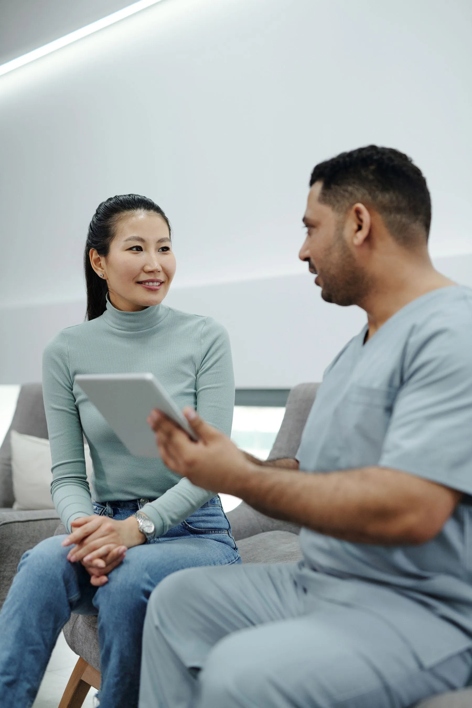 Patient discussing results with a nurse on a tablet