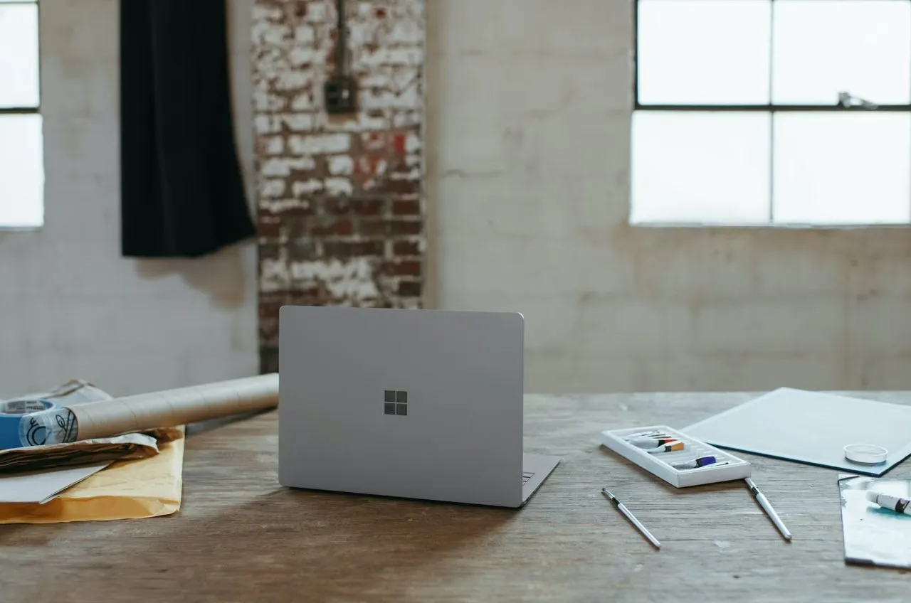 A laptop on a desk in a bright office
