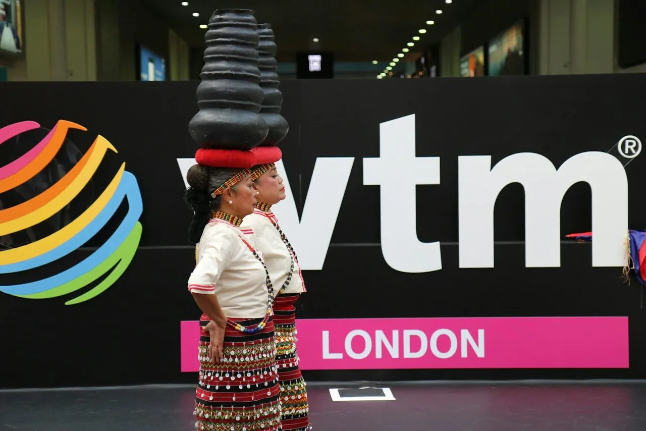 Performers in front of the WTM London sign at ExCeL London